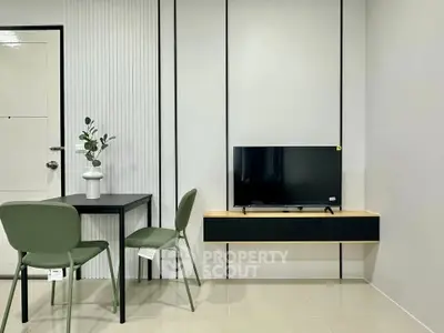 Modern minimalist living room with sleek TV setup and stylish dining area.