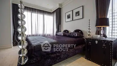Luxurious bedroom with elegant decor and large window for natural light.