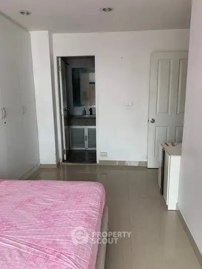 Cozy bedroom with ensuite bathroom and modern white wardrobe