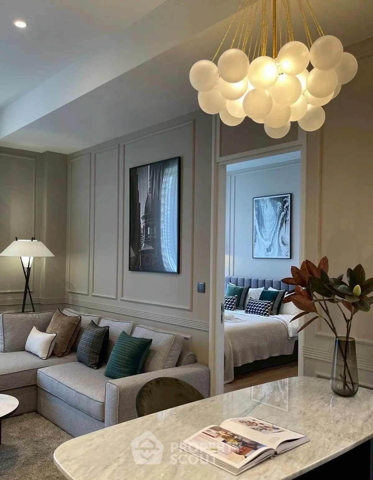 Luxurious living room with elegant chandelier and cozy bedroom view