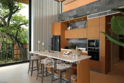 Luxurious modern kitchen with open layout and high ceilings, featuring sleek appliances and a stunning garden view.