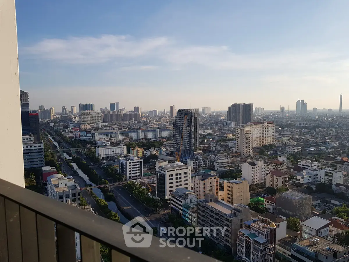 Stunning cityscape view from a high-rise balcony overlooking urban skyline.