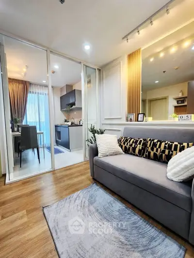 Modern living room with cozy sofa and stylish kitchen in open layout apartment.