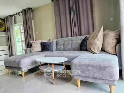 Stylish living room with modern gray sectional sofa and elegant decor