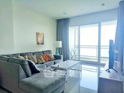 Spacious living room with modern decor and large windows offering natural light.