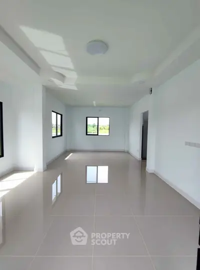 Spacious empty room with large windows and glossy tiled floor, perfect for customization.