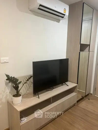 Modern living room with sleek TV stand and air conditioning