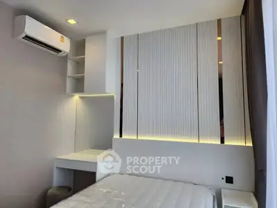 Modern bedroom with sleek design, featuring built-in shelves and ambient lighting.
