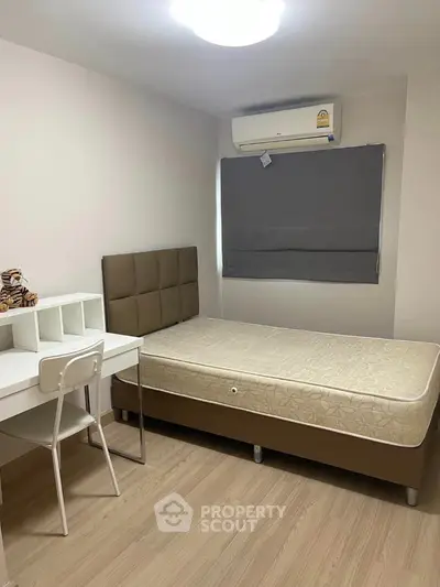 Cozy bedroom with modern furniture and air conditioning in a stylish apartment.