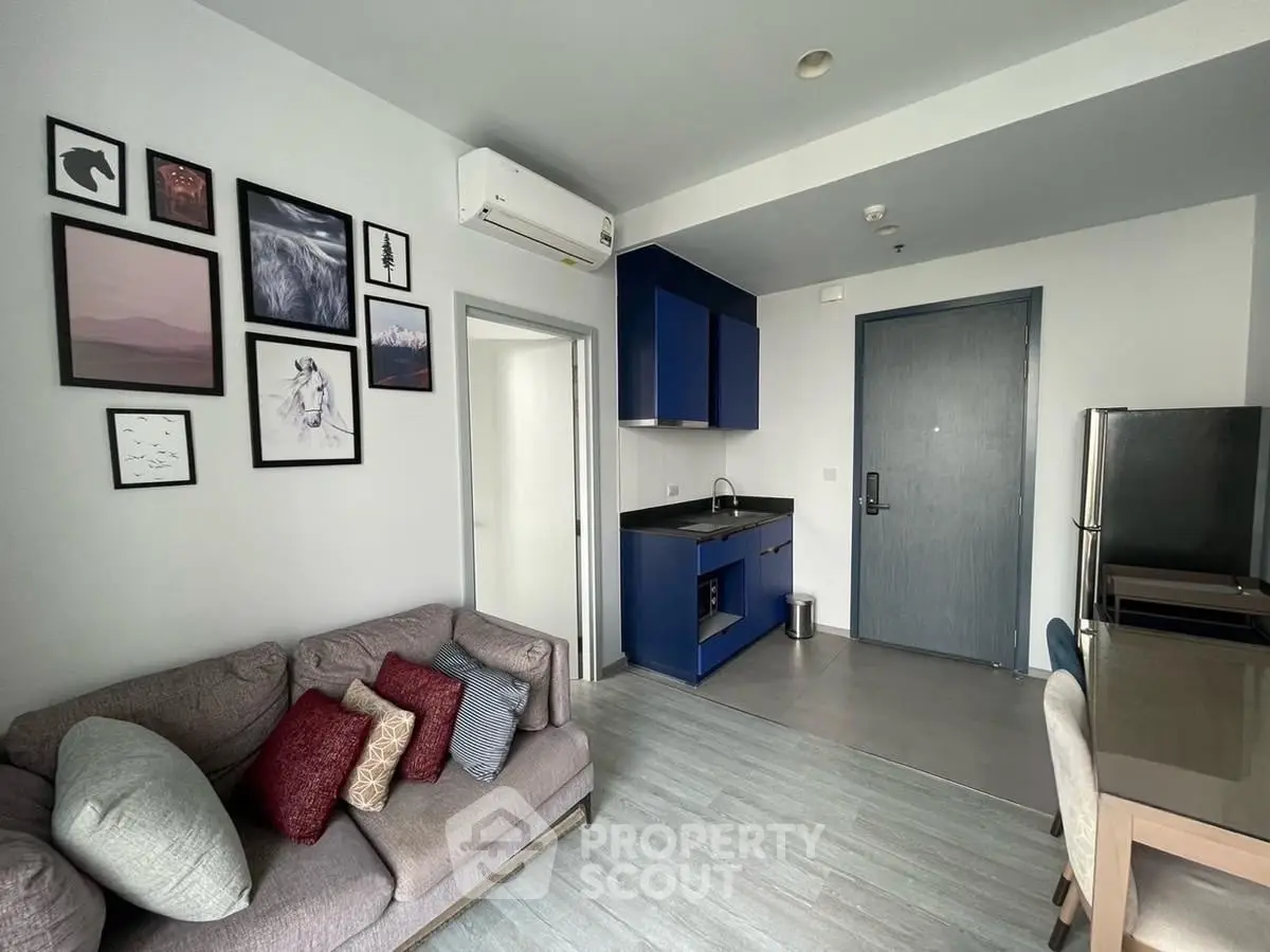 Modern living room with stylish decor and compact kitchen area