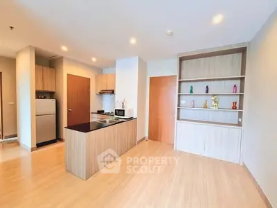 Modern kitchen with open layout and sleek wooden flooring