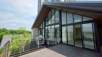 Stunning modern balcony with glass railing and city view, perfect for relaxation and entertainment.