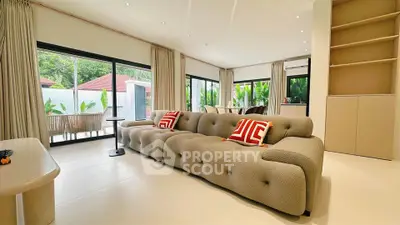 Spacious modern living room with plush sofa and garden view, perfect for relaxation and entertaining.