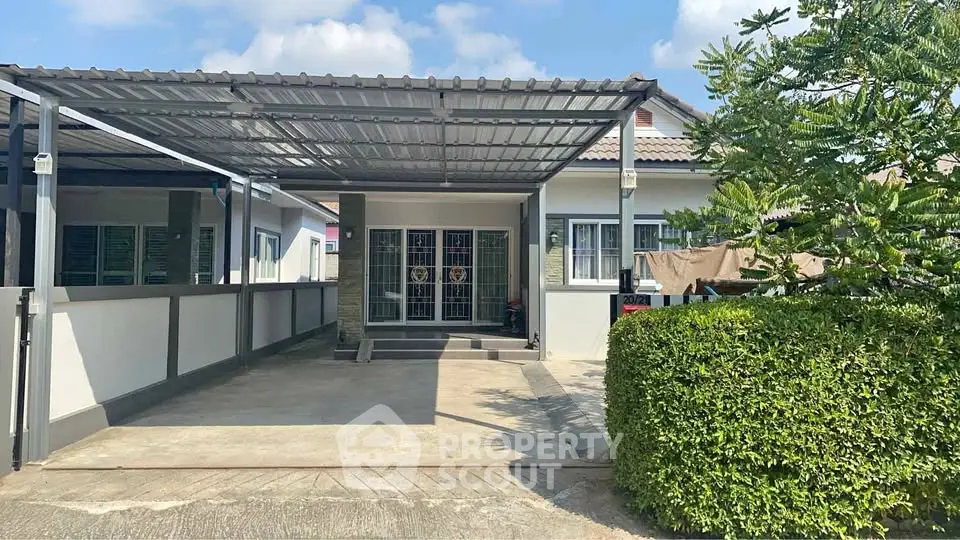 Charming single-story home with covered carport and lush greenery