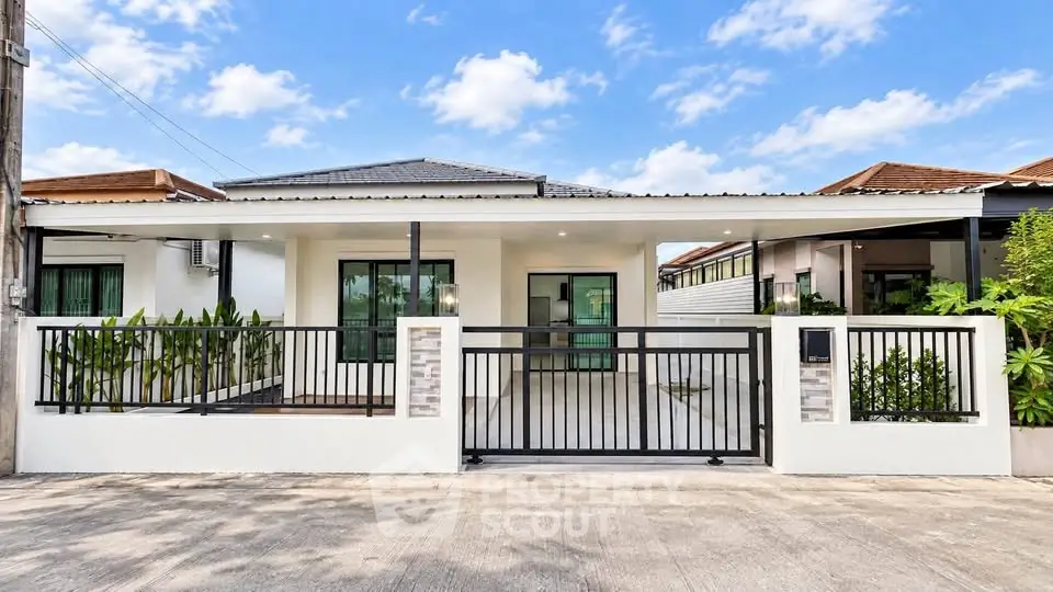 Charming single-story home with modern facade and lush greenery, perfect for family living.