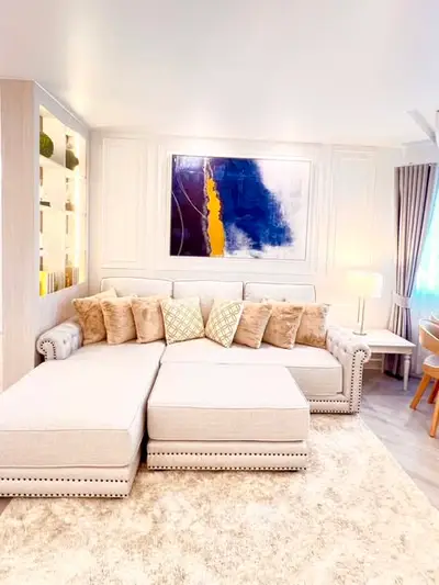 Luxurious living room with plush sectional sofa and modern art decor.