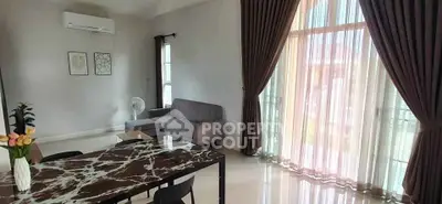 Spacious living room with elegant marble dining table and large windows