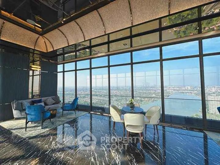 Luxurious high-rise lounge with panoramic city and river views, elegant seating, and marble flooring.
