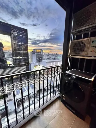 Stunning city view from high-rise balcony with modern appliances, perfect urban living.
