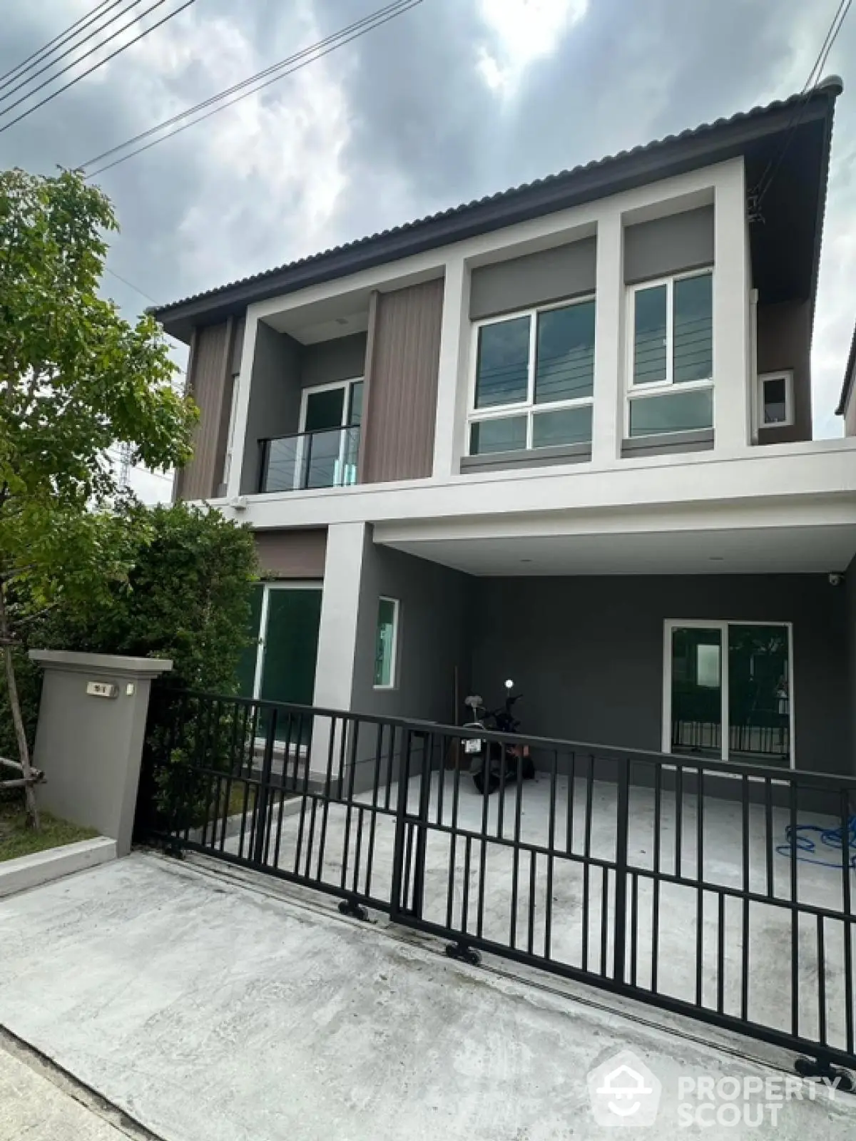 Modern two-story house with sleek facade and spacious driveway