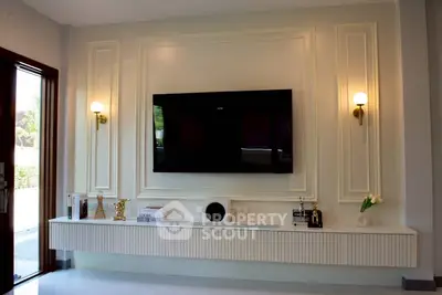 Elegant living room with modern TV setup and stylish wall sconces