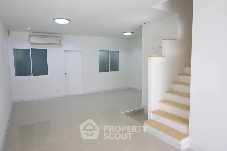 Spacious modern living room with sleek staircase and minimalist design