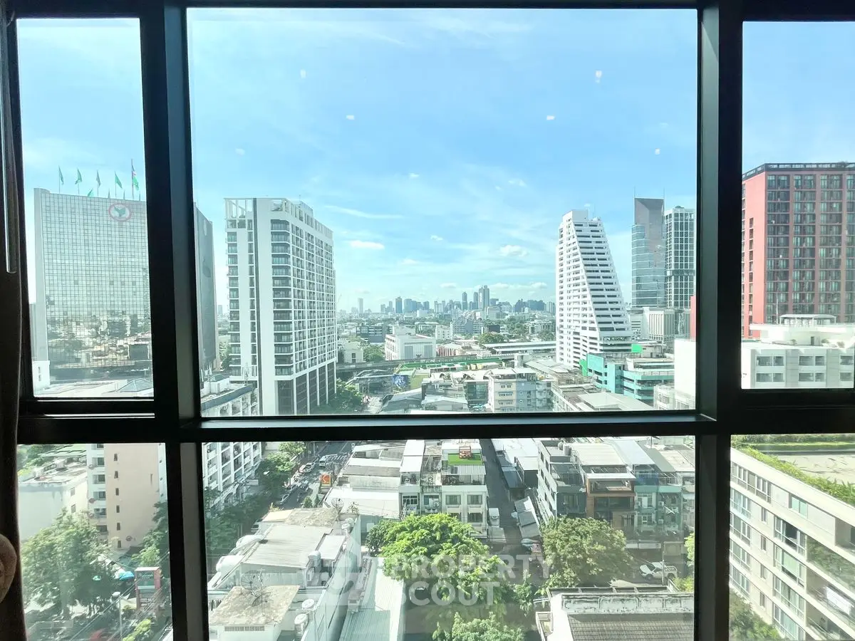 Stunning cityscape view from high-rise building window showcasing urban skyline.