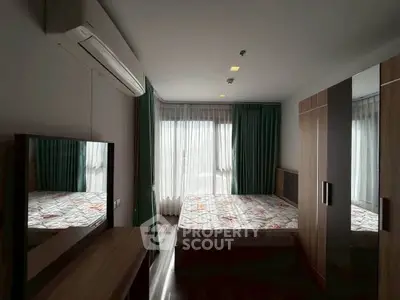 Cozy bedroom with modern furnishings and large window for natural light.