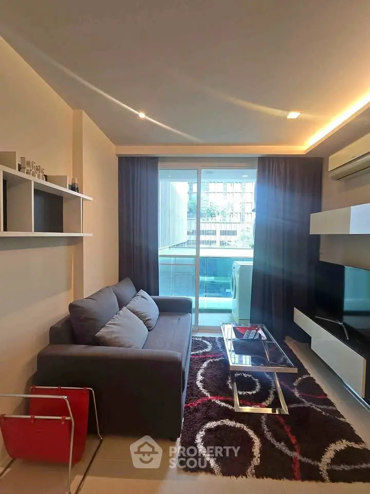 Modern living room with sleek furniture and balcony view in urban apartment