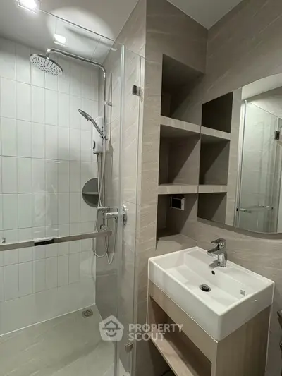 Modern bathroom with sleek shower and stylish sink in contemporary design.