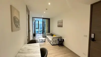 Modern living room with stylish decor and open balcony view.