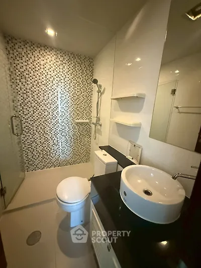 Modern bathroom with stylish mosaic shower and sleek fixtures