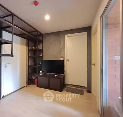 Modern living room with sleek shelving and TV unit, ideal for cozy urban living.