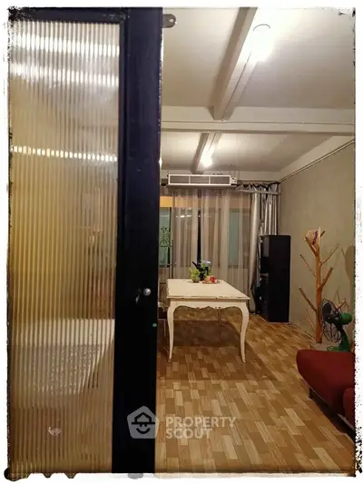 Charming living room with stylish decor and wooden flooring, perfect for cozy gatherings.