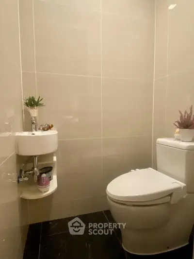 Modern minimalist bathroom with sleek fixtures and elegant tile design.