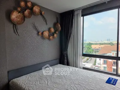 Modern bedroom with artistic wall decor and large window offering city view