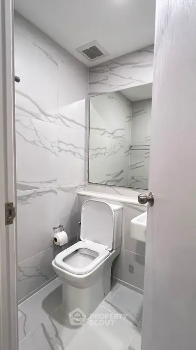 Modern bathroom with marble tiles and sleek fixtures