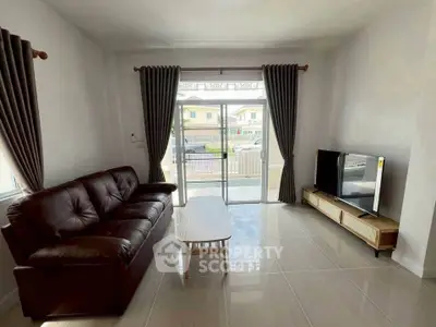 Spacious living room with modern furniture and large window view