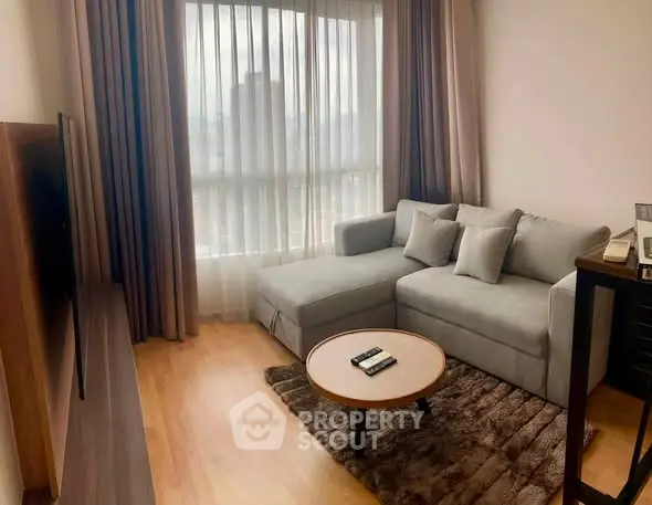 Cozy living room with modern sofa and large window offering city view