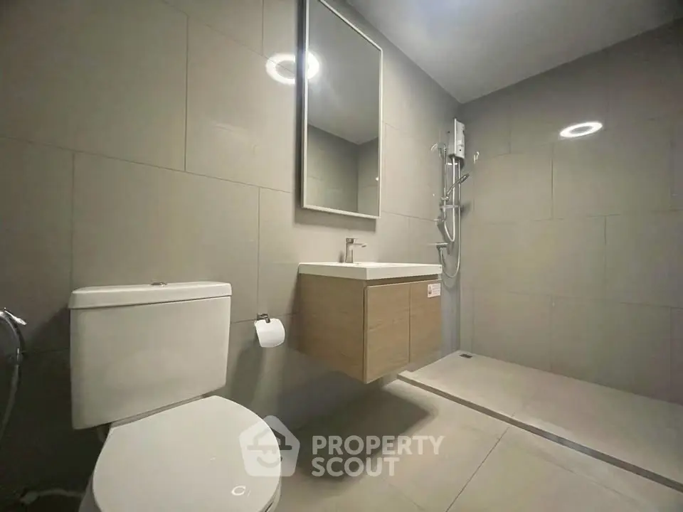 Modern bathroom with sleek fixtures and spacious shower area