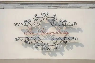 Elegant decorative sign with intricate metalwork at The Bloomsbury entrance.