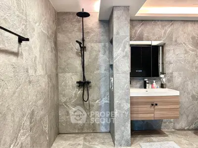 Modern bathroom with sleek design featuring a walk-in shower and stylish vanity.