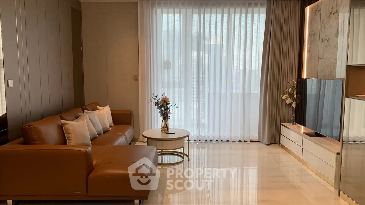 Luxurious modern living room with elegant decor and large windows for natural light.