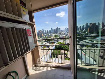 Stunning city view from a high-rise balcony with modern skyline in the background.