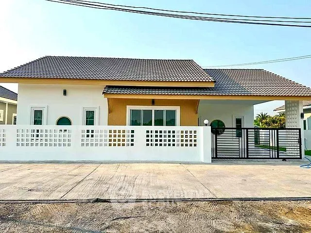 Charming single-story house with modern design and spacious driveway in a serene neighborhood.