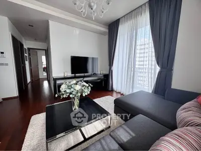 Modern living room with elegant decor and city view, featuring a cozy sofa and stylish coffee table.