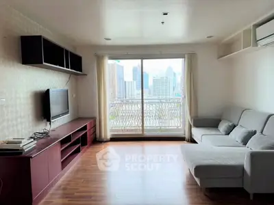 Spacious living room with city view, modern furniture, and large windows for natural light.
