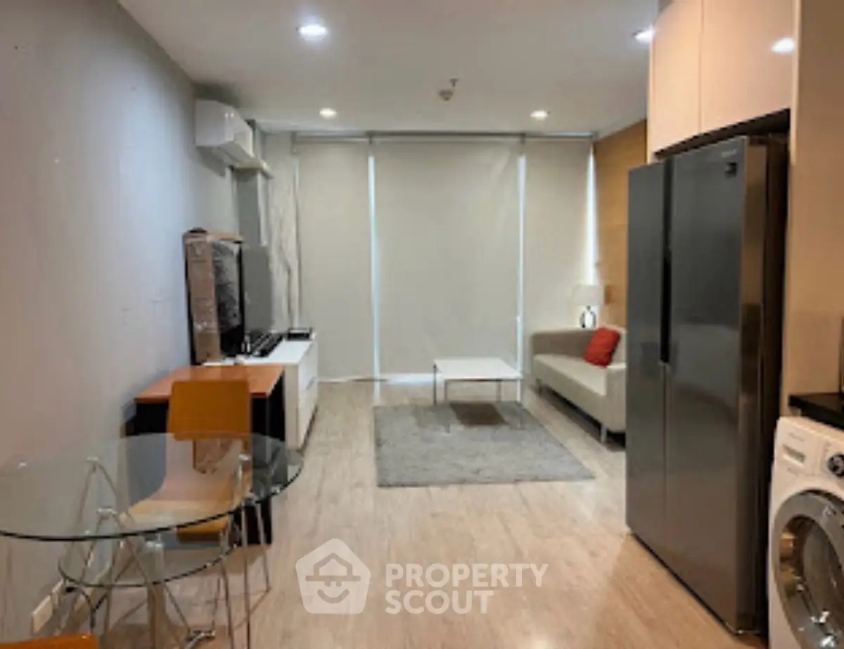 Modern living room with sleek furniture and appliances, featuring a cozy seating area and stylish decor.