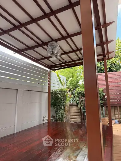 Charming wooden deck with pergola, perfect for outdoor relaxation and entertainment.