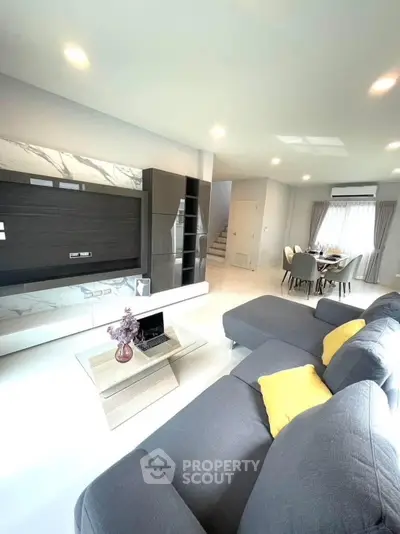 Spacious modern living room with stylish decor and ample natural light, perfect for relaxation and entertainment.